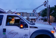 An Oncor crew works along Elsie Faye Heggins Street as power outages continue across the...