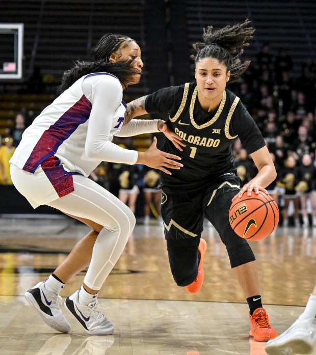BOULDER , CO - FEBRUARY 8: Zyanna Walker (1) of the Colorado Buffaloes drives on Taylor Bigby (1) of the TCU Horned Frogs during the fourth quarter of the Buffs' 80-79 win at the CU Events Center in Boulder, Colorado on Sunday, February 8, 2026. (Photo by AAron Ontiveroz/The Denver Post)
