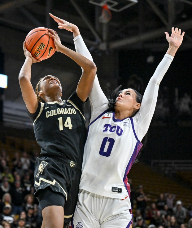 BOULDER , CO - FEBRUARY 8: Jade Masogayo (14) of the Colorado Buffaloes makes a shot and draws a foul from Kennedy Basham (0) of the TCU Horned Frogs to set up the game-winning free throw during the fourth quarter of the Buffs' 80-79 win at the CU Events Center in Boulder, Colorado on Sunday, February 8, 2026. (Photo by AAron Ontiveroz/The Denver Post)