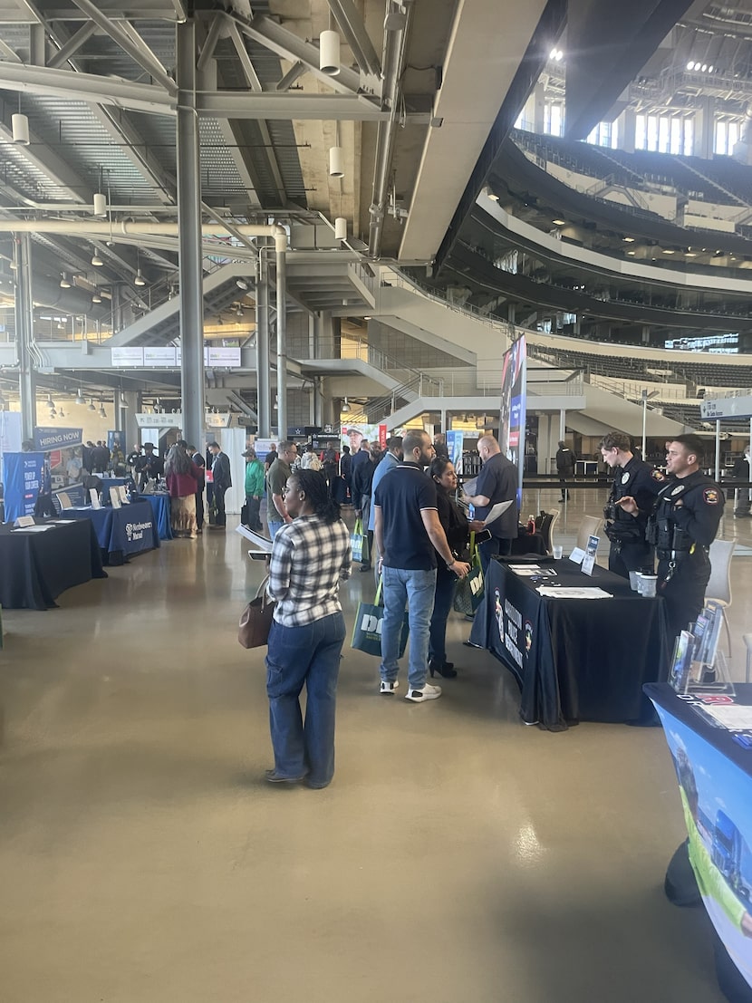 Job seekers mingle with recruiters during the DAV and RecruitMilitary job fair in Arlington...