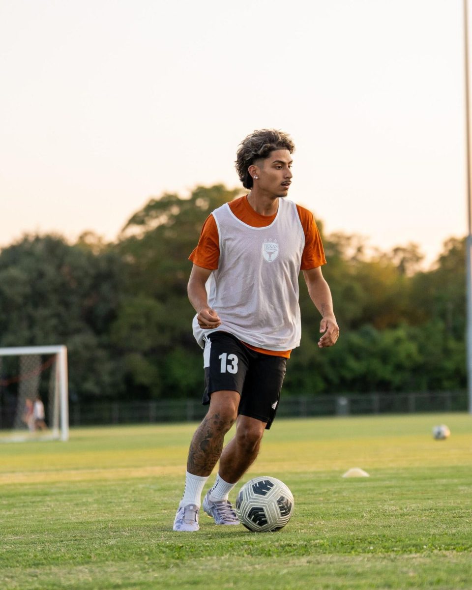Male students help Texas soccer practice during spring season as practice players