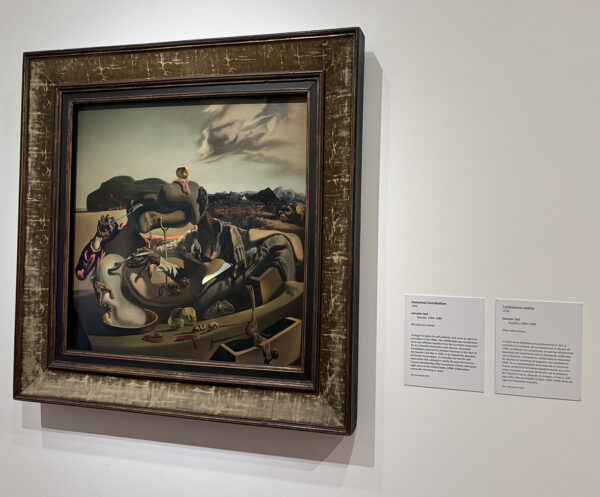 A surreal painting by Salvador Dalí featuring two amorphous figures appearing to jab each other with utensils. 