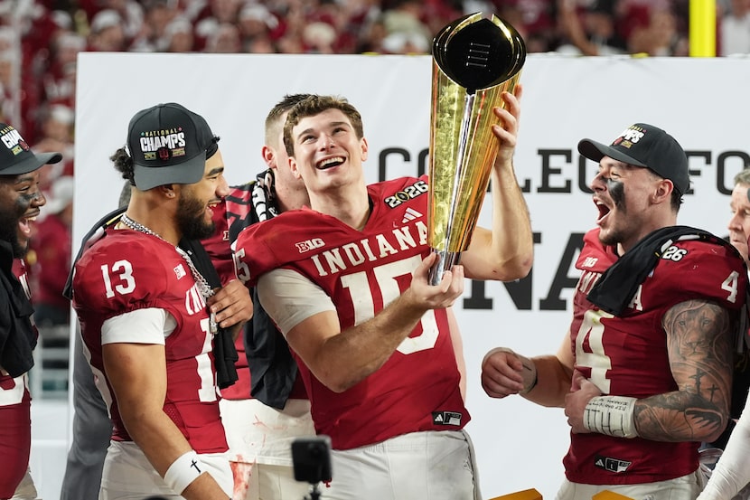 Indiana quarterback Fernando Mendoza (15) holds the trophy after Indiana defeated Miami in a...