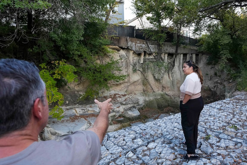 Joseph Beckham and Yesenia Serrano pause on the banks of Coombs Creek as they view erosion...