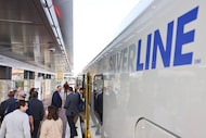 People board the newly inaugurated DART Silver Line as it prepares depart for the next...