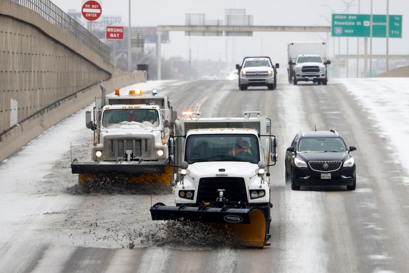 TxDOT trucks plow and treat Interstate 35W with brine, Saturday, Jan. 24, 2026, in Fort Worth.