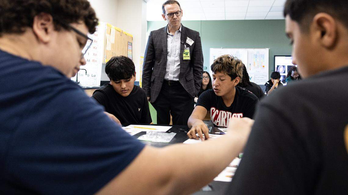 Mike Morath, the Texas Commissioner of Education, interacts with students on their classwork in a science class at Lucyle Collins Middle School in Lake Worth on Tuesday, Oct. 21, 2025.
