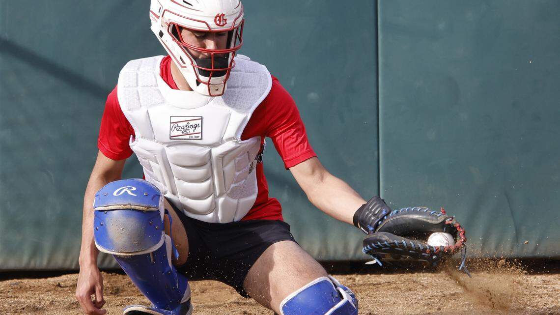 Grapevine catcher Gianni Corral picks one out of the dirt in the pitching cage during Grapevine Mustang baseball practice at Grapevine High School in Grapevine, Texas, Tuesday Feb. 17, 2026.