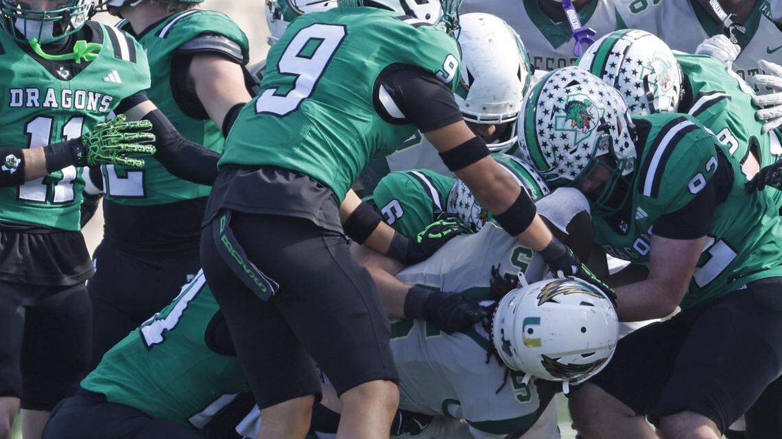 DeSoto running back Sarod Baker is engulfed by the Southlake Carroll defense during a 6A Division 2 playoff game in December. All 6A schools are required to report concussion data to the UIL.