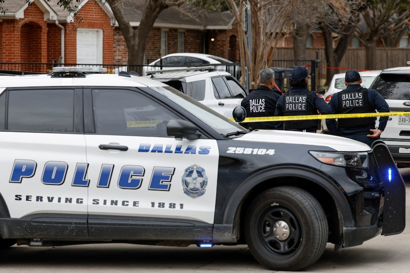 Dallas police work the scene of an officer-involved shooting near Shaw Street and North...