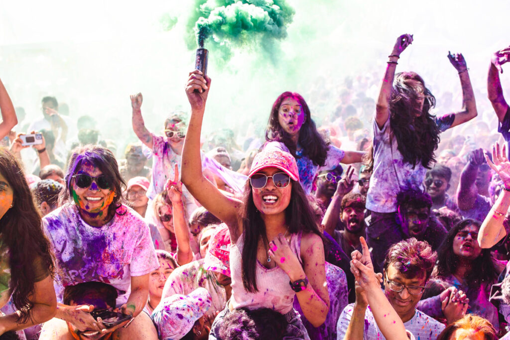 Image shows festival goers at Holi Houston in color powder.