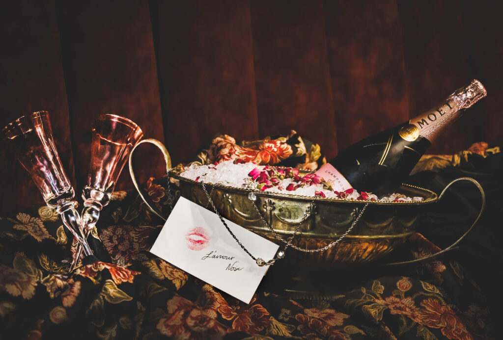 Image shows a display of cocktails and thematic elements for the L'Amour Noir pop-up in Houston.