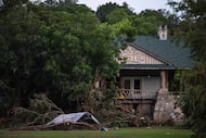 FILE - Debris covers the area of Camp Mystic in Hunt, Texas, July 7, 2025, after a flash...