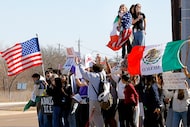 Mia Sotelo, top, shouts through a bullhorn during a protest over immigration policy at the...