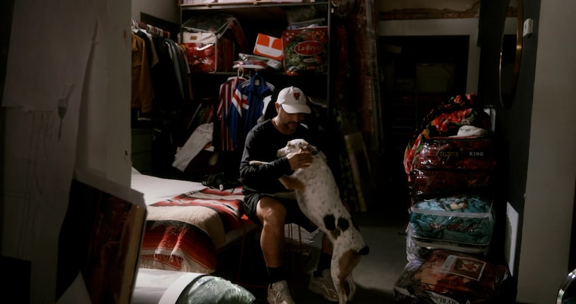 Antonio Lechuga pets his dog, Chanclas, before a run. “One of the many goals that I had...