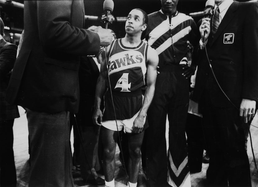 Spud Webb looks up at interviewers after winning the NBA All-Star weekend Slam-Dunk...