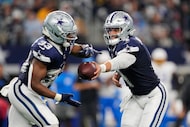 Dallas Cowboys quarterback Dak Prescott (4) hands off to running back Javonte Williams (33)...