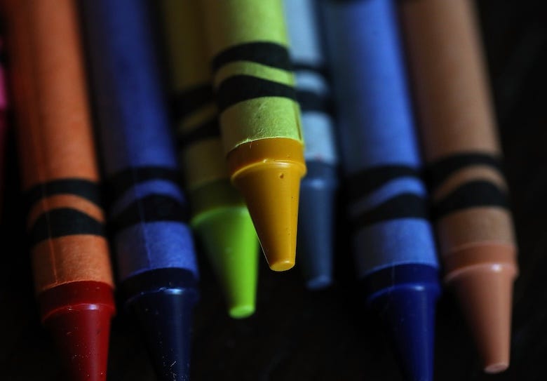 Crayons against a black background