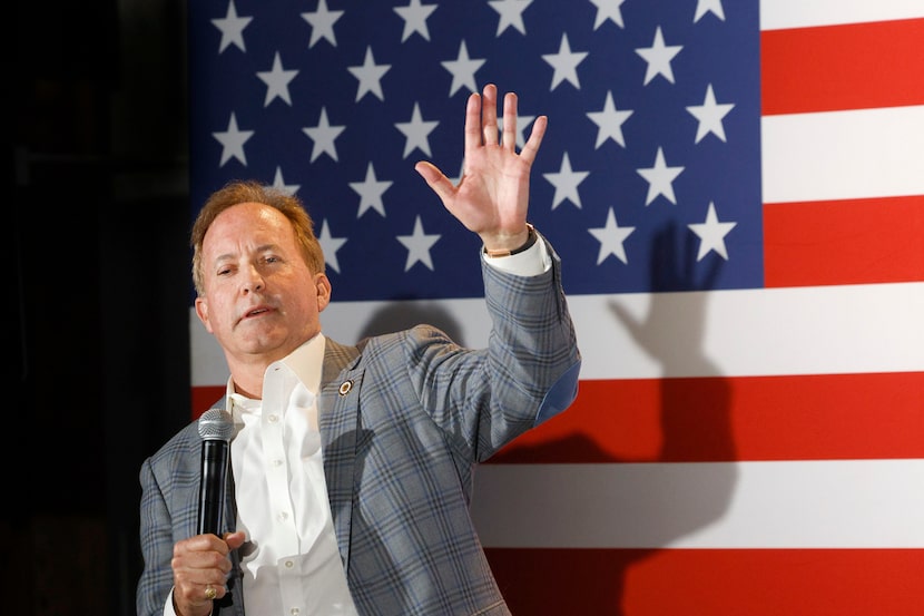 Texas Attorney General Ken Paxton waves during a campaign event at Matt's Rancho Martinez,...