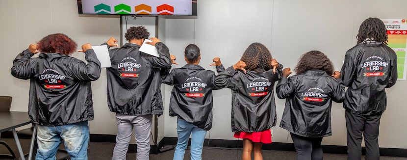 Students show off their jackets at a Leadership Lab brought to Paul Quinn College by Toyota...