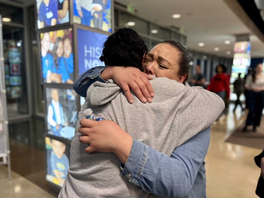 Parents cry and embrace after the HISD board votes to close 12 schools