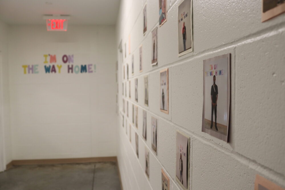 In Houston's Navigation Center, a wall shows people who have successfully moved from homelessness into housing.