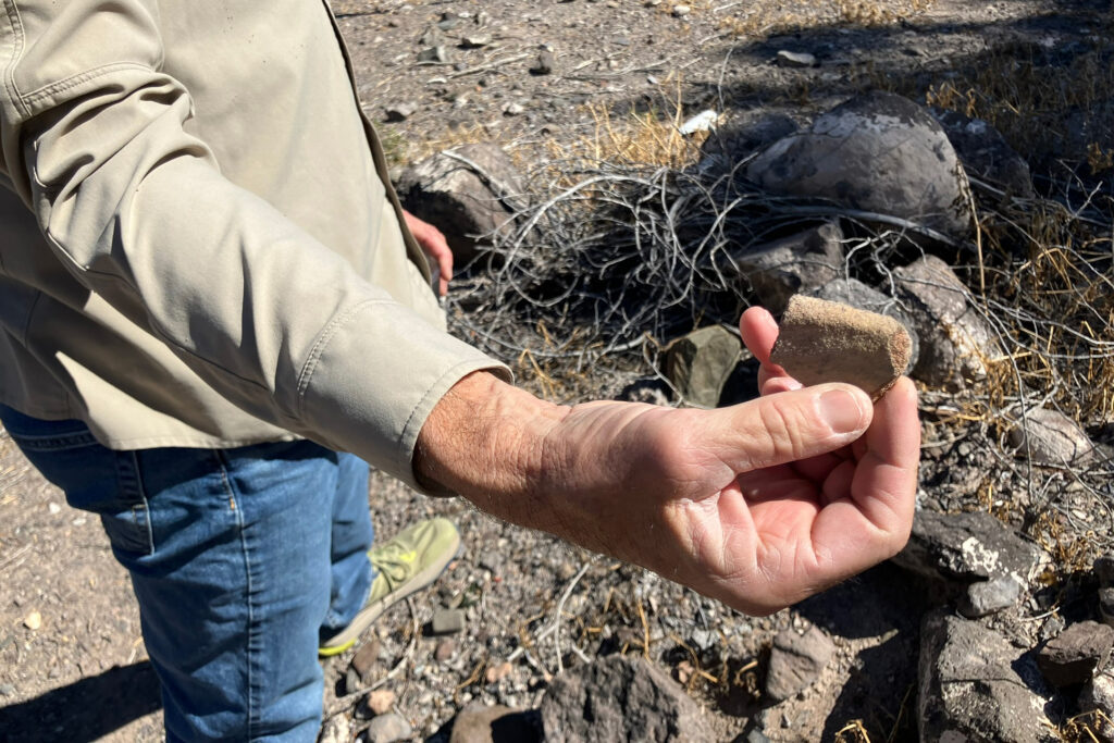 River guide Charlie Angell holds a pottery shard from the El Polvo archeological site near his home on Feb. 16. Credit: Martha Pskowski/Inside Climate News