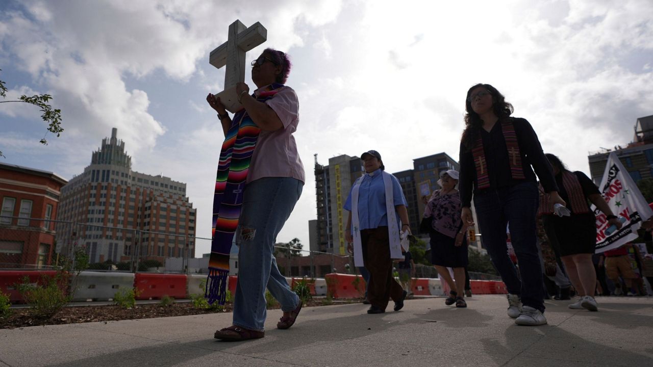 Immigration advocates protest recent detentions by ICE outside the immigration court in San Antonio, Texas, Tuesday, July 1, 2025. (AP Photo/Eric Gay)