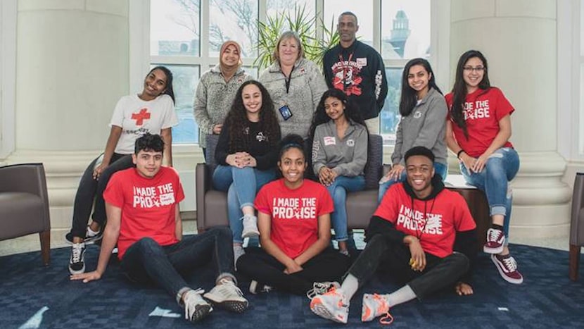 A multiracial group of college-age students and their success coaches appear in a photo for...