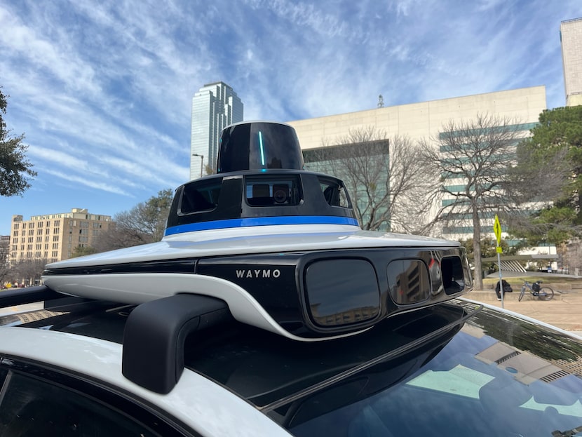 The top sensor unit on a Waymo robotaxi is shown in downtown Dallas during a preview ride...