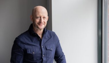 Man in navy shirt against gray wall