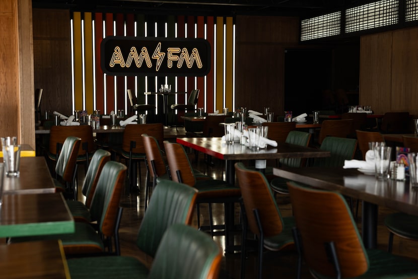 Under the AM/FM neon logo is a stage for occasional live music at the new diner. Behind the...