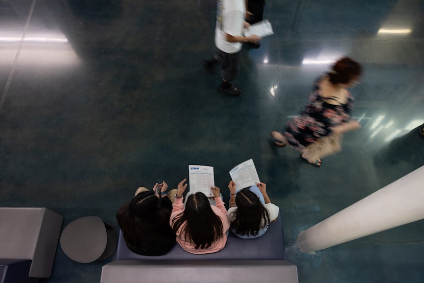 Students read through a list of courses during an open house at Garland ISD’s Gilbreath-Reed...