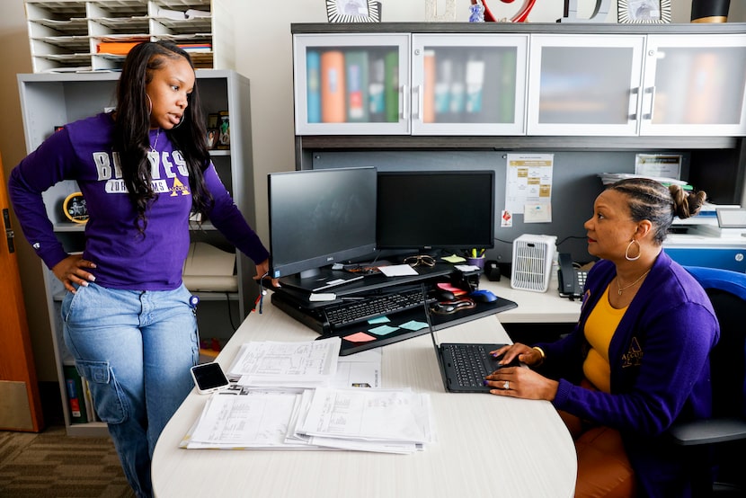 Kendall Gray (left) and Gala Davis (right), both guidance counselors, catch up and talk in...