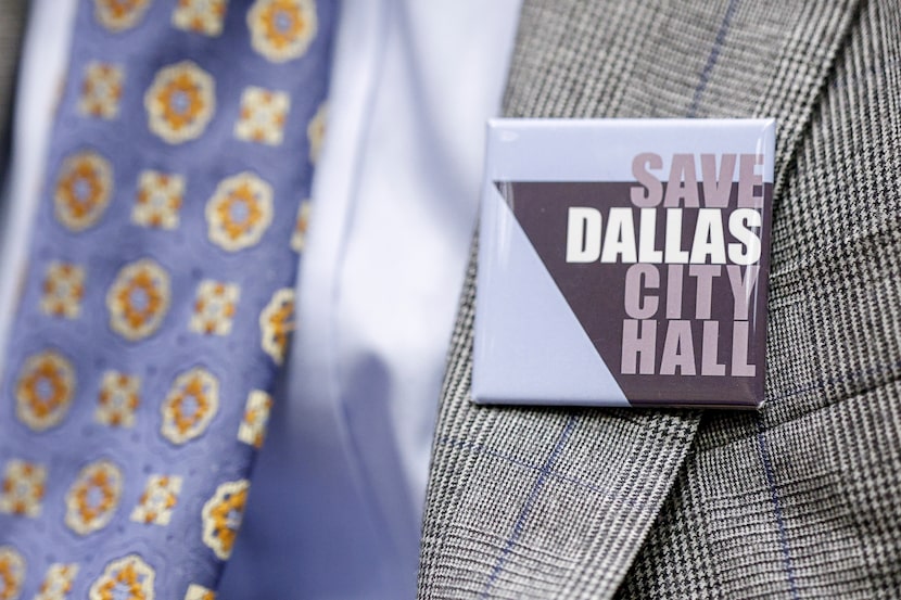 A man wears a “Save Dallas City Hall” button during a Dallas City Council Committee on...