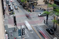 Traffic travels through the intersection of Main Street and Akard Street on Friday, March...