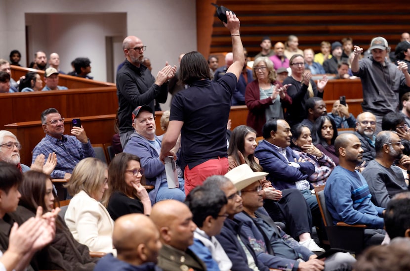 Marc Palasciano of Garland waves to supporters who cheered after he spoke out about the...