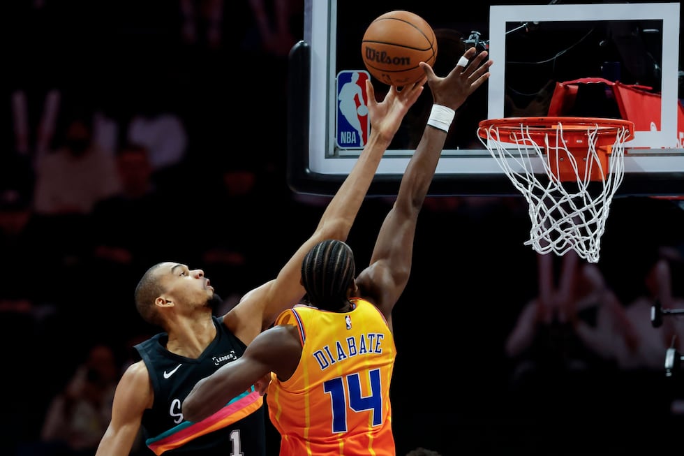 San Antonio Spurs forward Victor Wembanyama, left, shoots against Charlotte Hornets forward...