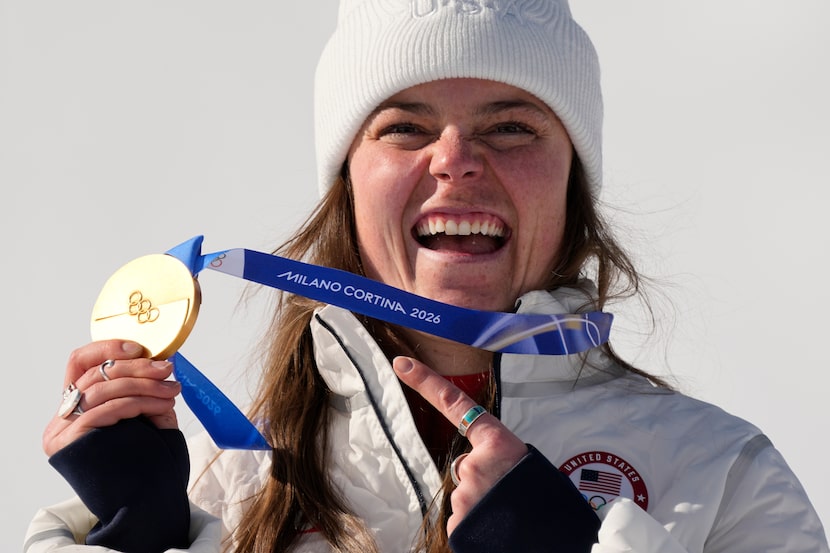United States' Breezy Johnson shows her gold medal in the alpine ski women's downhill race,...