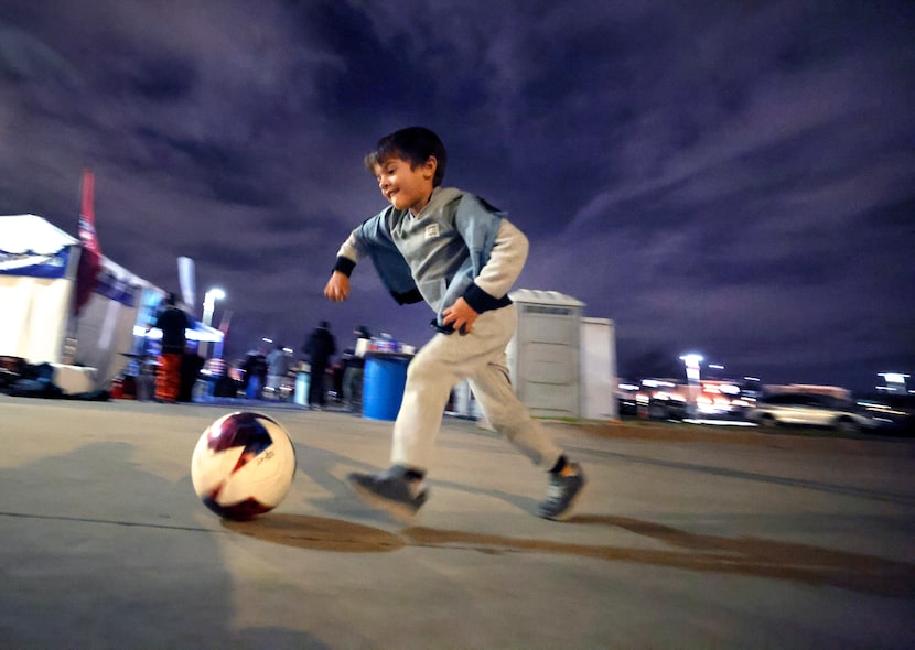 Young FC Dallas supporter Mateo Larramendi, 4, of Denton kicks a soccer ball around the...