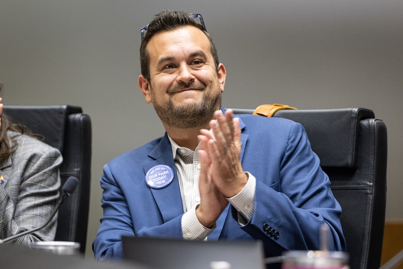 Dallas City Council member Adam Bazaldua applauds after a council decision to give Fair Park...