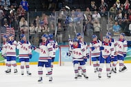 United States players celebrate at the end of a men's ice hockey semifinal game between the...