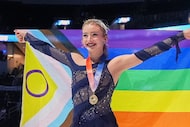 Gold medalist Amber Glenn poses with a flag after the women's free skating competition at...