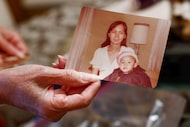 Jennifer Nguyen shows a family photo with one of her children at her home, Monday, Nov. 24,...