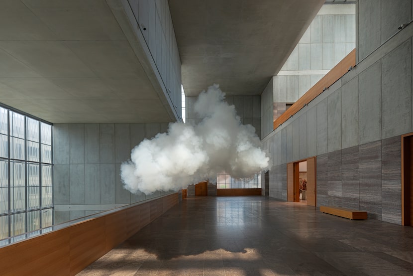 The clouds come indoors in Berndnaut Smilde's 2021 digital C-type print "Nimbus Mdbk" and...