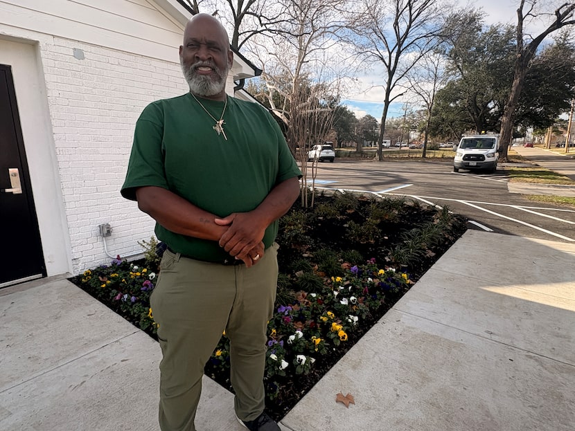 Lotis Charles Qualls stands in front of Zan Wesley Holmes, Jr. Community Outreach Center, a...