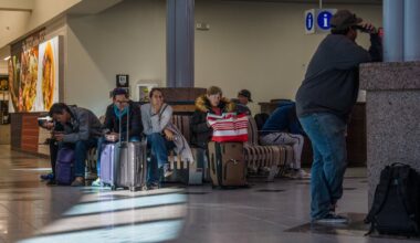 Passengers wait on benches after an abrupt closure and reopening of El Paso International Airport in El Paso.