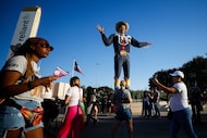 Attendees walked past Big Tex at the State Fair of Texas in Dallas. The State Fair stopped...