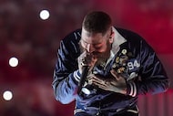 Post Malone performs during halftime of an NFL football game between the Dallas Cowboys and...