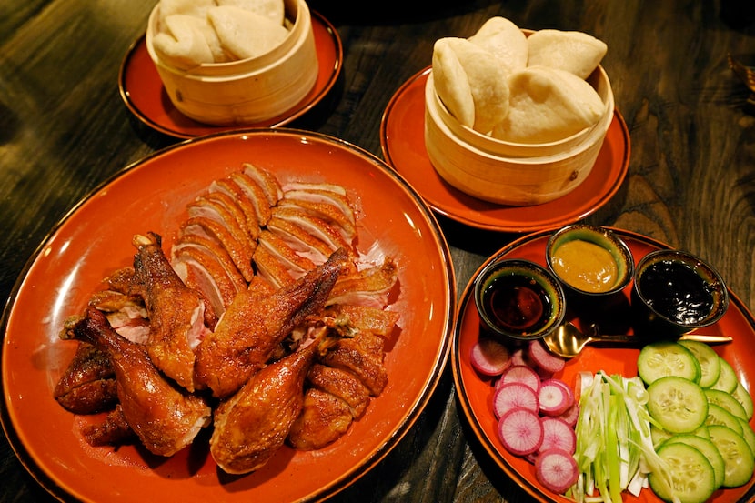 Tea-smoked duck is the priciest item at Night Rooster. Diners can share a whole duck among...